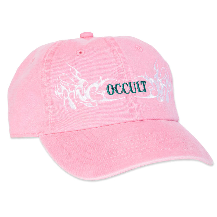 NYC based graphic apparel streetwear brand Locus Occult new hat, pink low profile dad baseball cap with embroidered Y2K flames surrounding occult on front and two cheeky dancing devils embroidered on back. Ivory and emerald green embroidery on washed bubblegum pink.